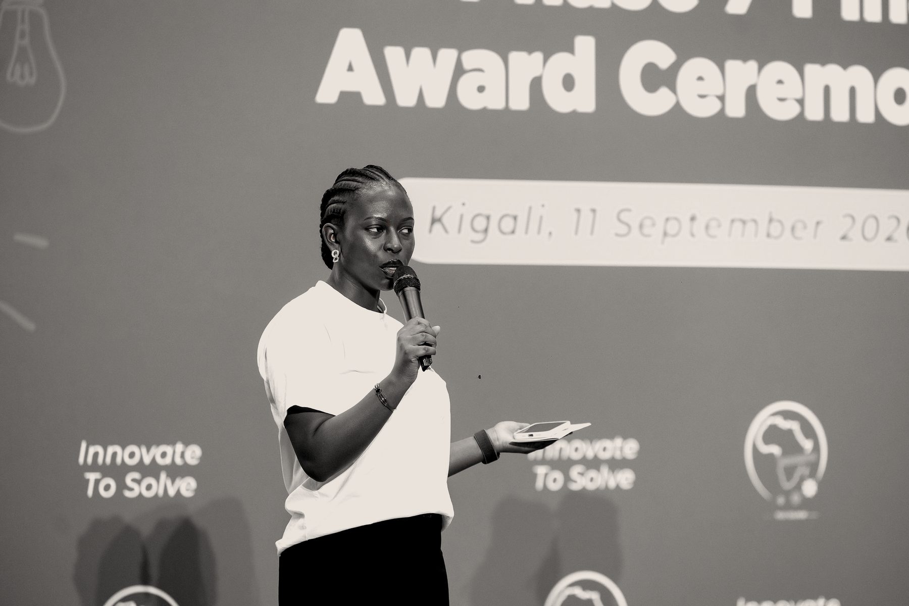 Doria speaking on stage with a microphone
